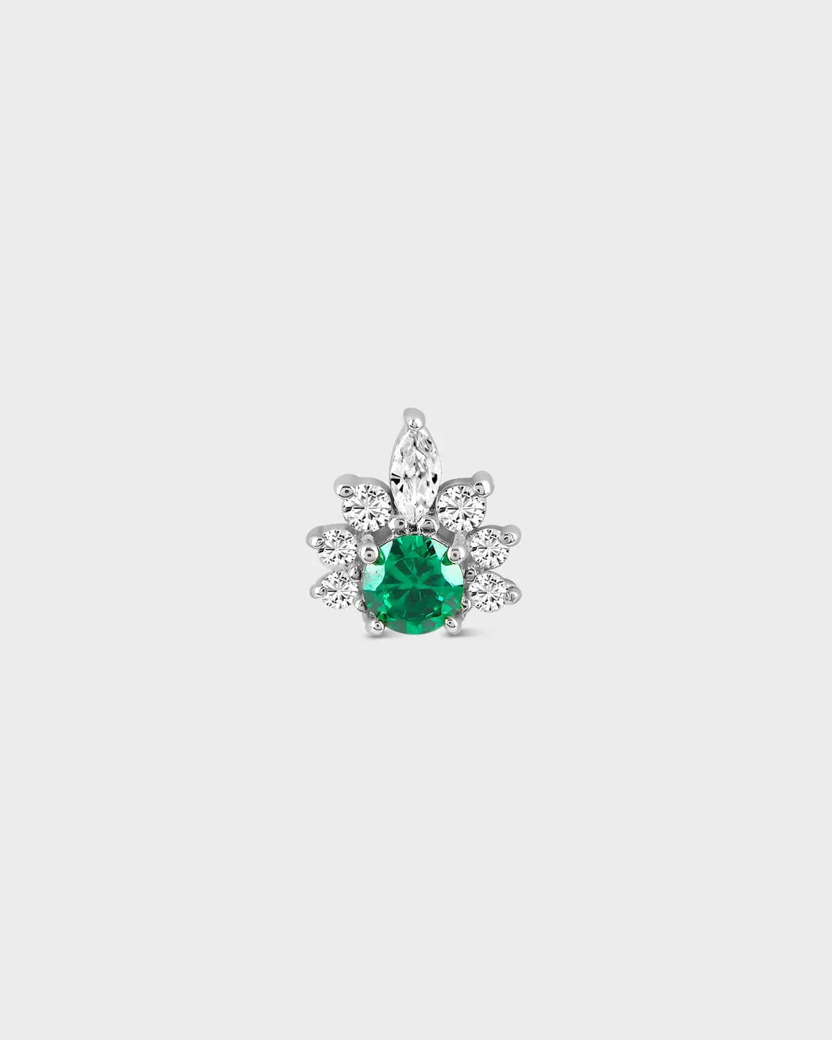Silver earring with a green gemstone on a white background