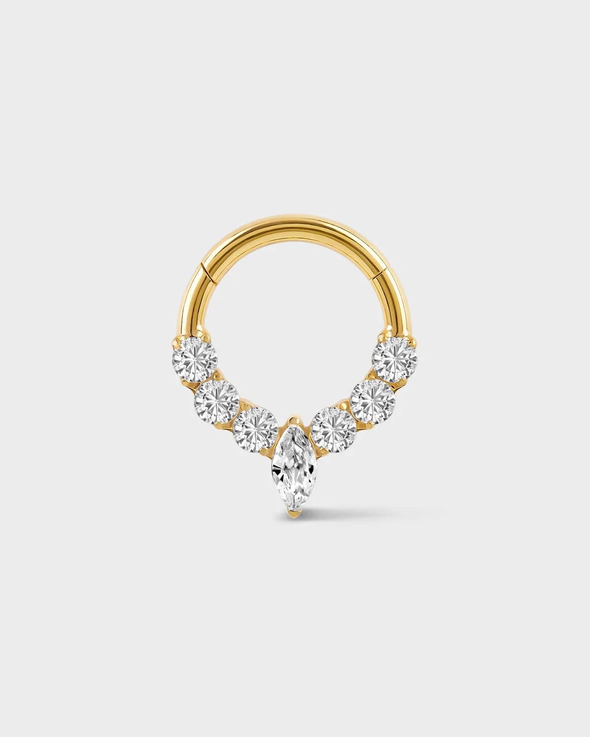 Gold daith ring with central marquise gemstone and three gem either side on a light gray background