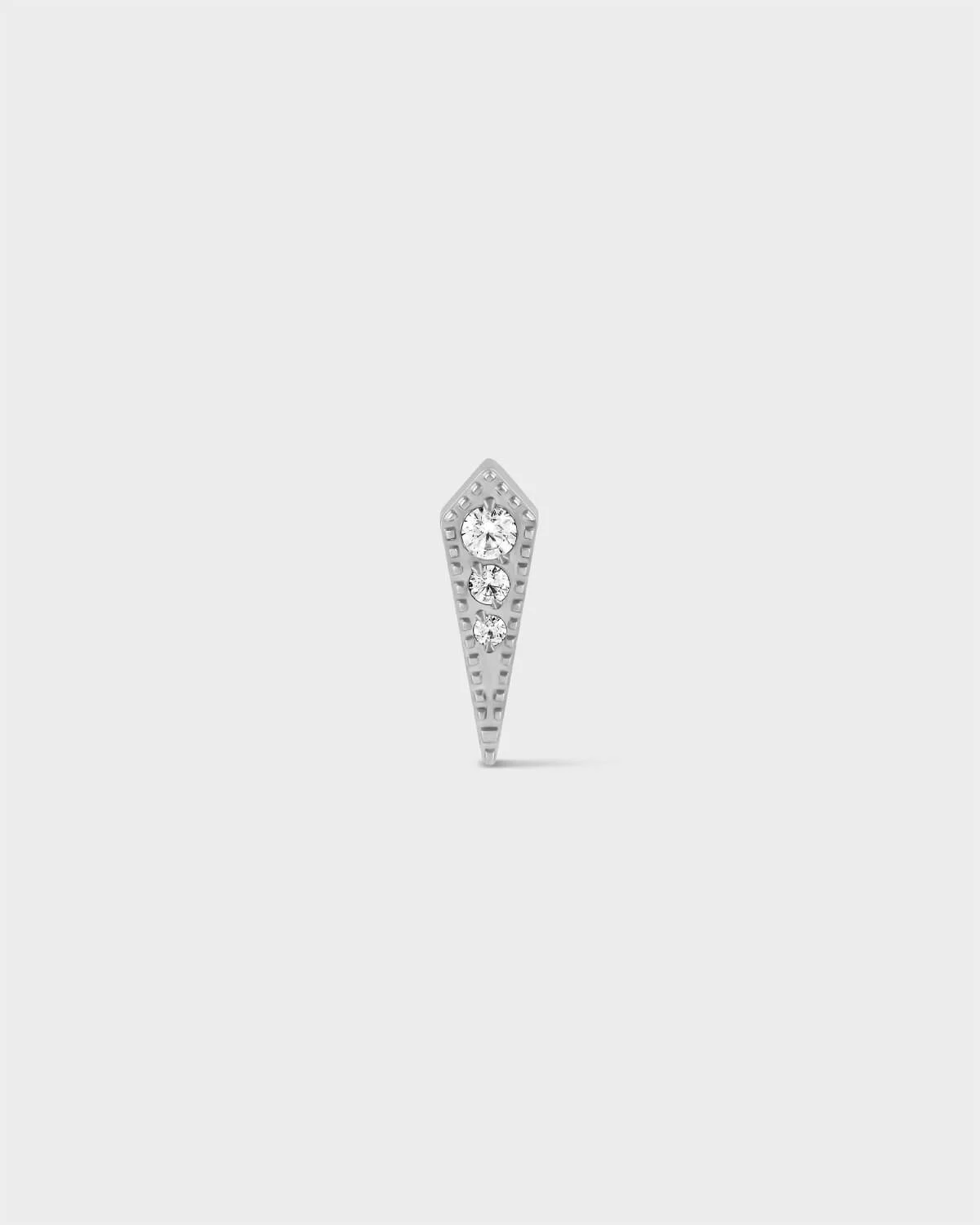 Polished titanium kite earring with triple gemstones and milgrain detail on a light grey background.