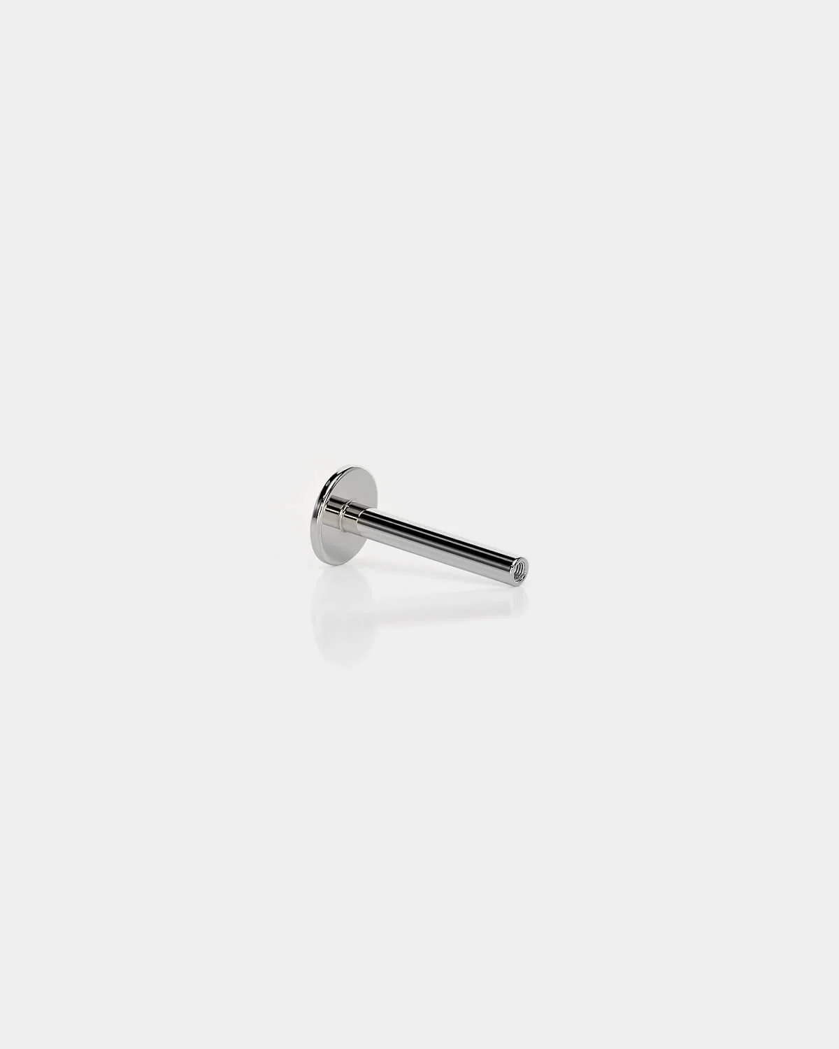 Internally threaded titanium labret back in polished silver with a 4mm base and 16g shaft on a light gray background