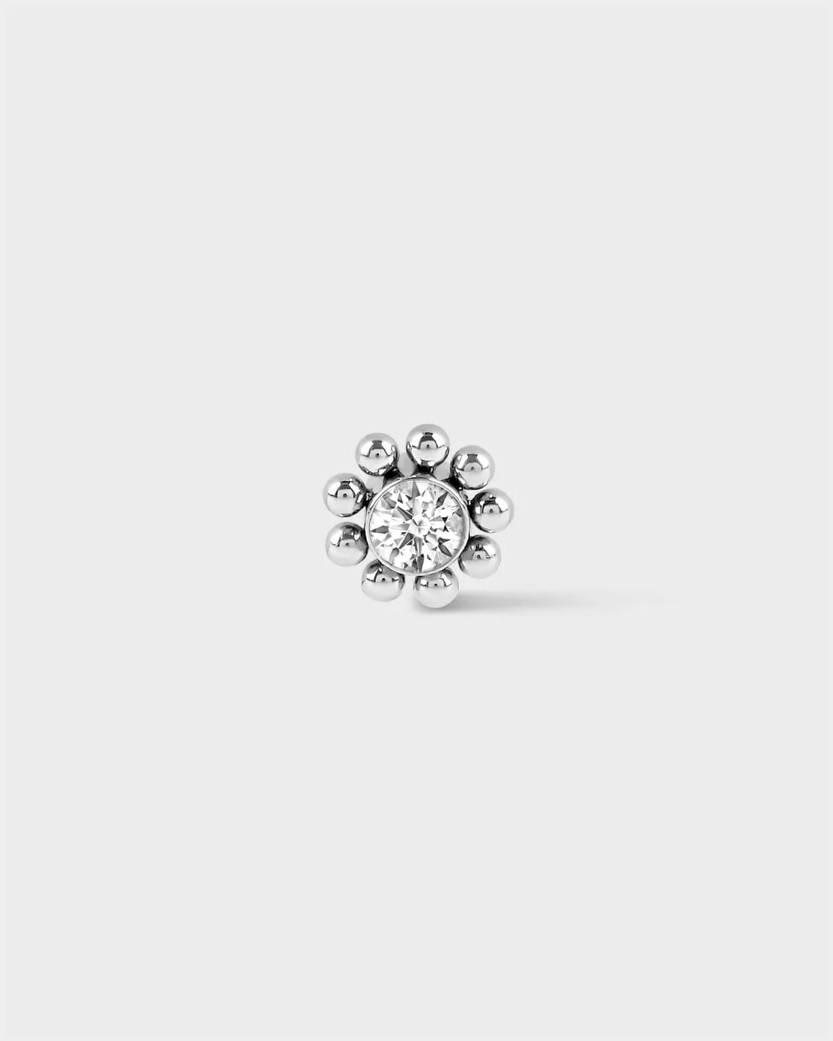 Polished silver  titanium Full beaded solitaire earring on light grey background