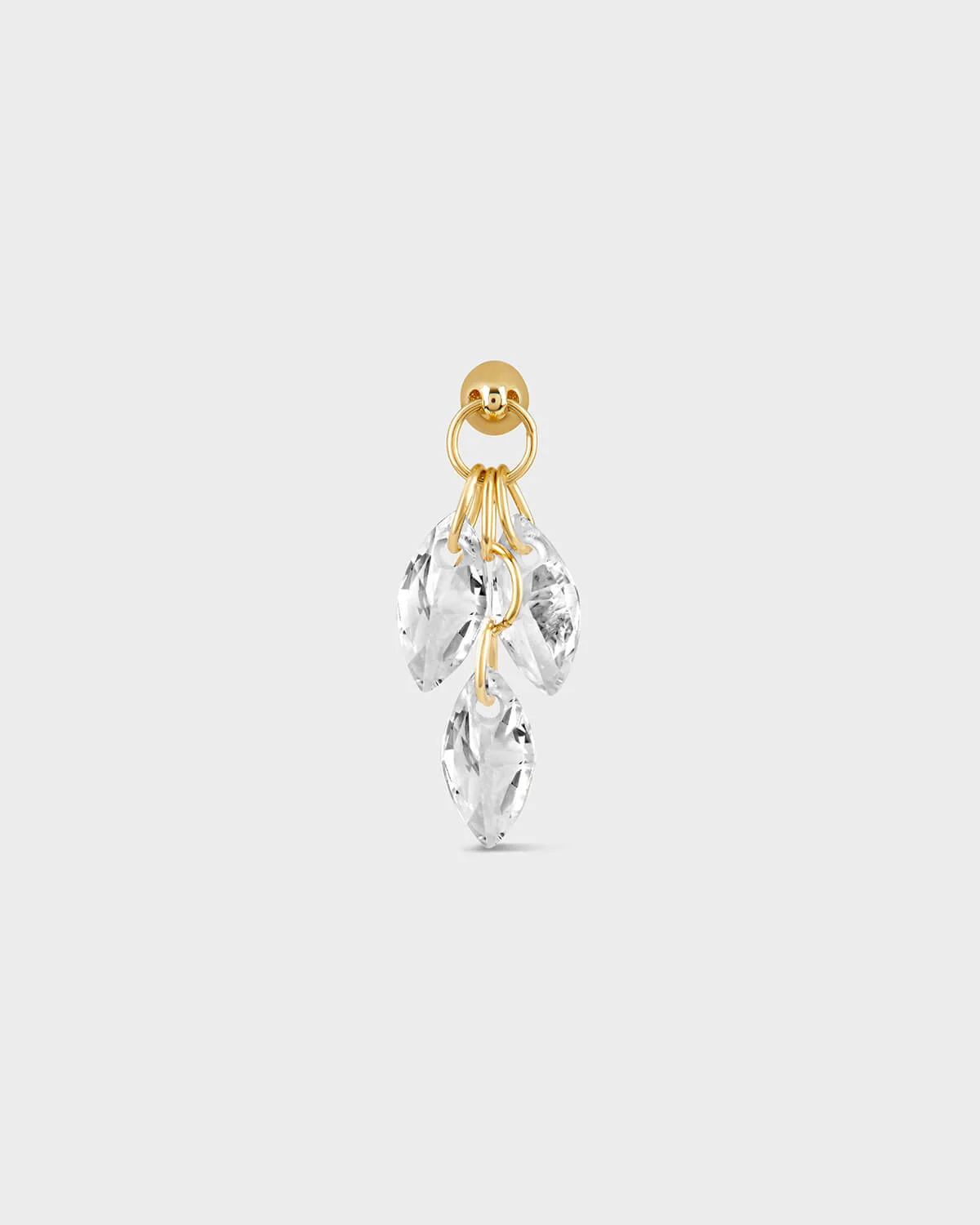 Gold earring with clear crystal stones on a white background