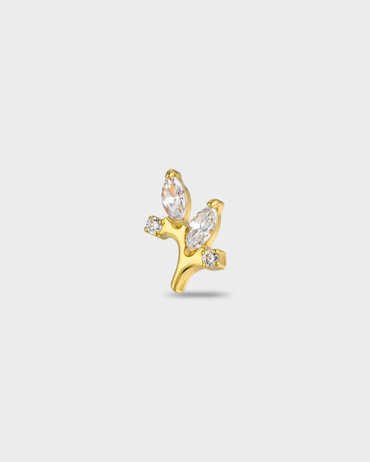 Gold titanium earring with two marquise-cut clear stones and two smaller round-cut clear stones set on a curved base on a light gray background.